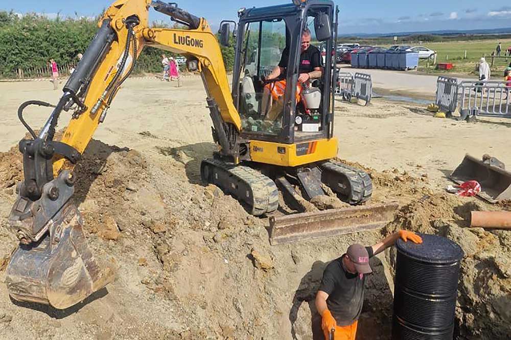 Digger on site fixing blocked drainage