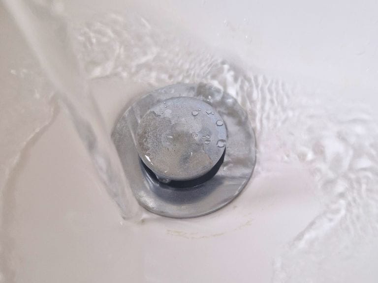 Sink plug hole with running water
